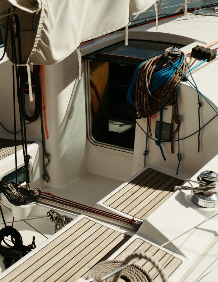 Detail view of a luxury yacht deck in Cannes with nautical ropes and equipment.