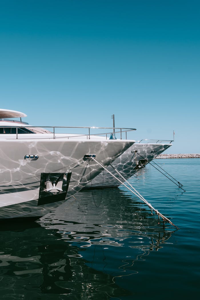Stylish yachts docked at Marbella's sunny marina, reflecting ocean tranquility.
